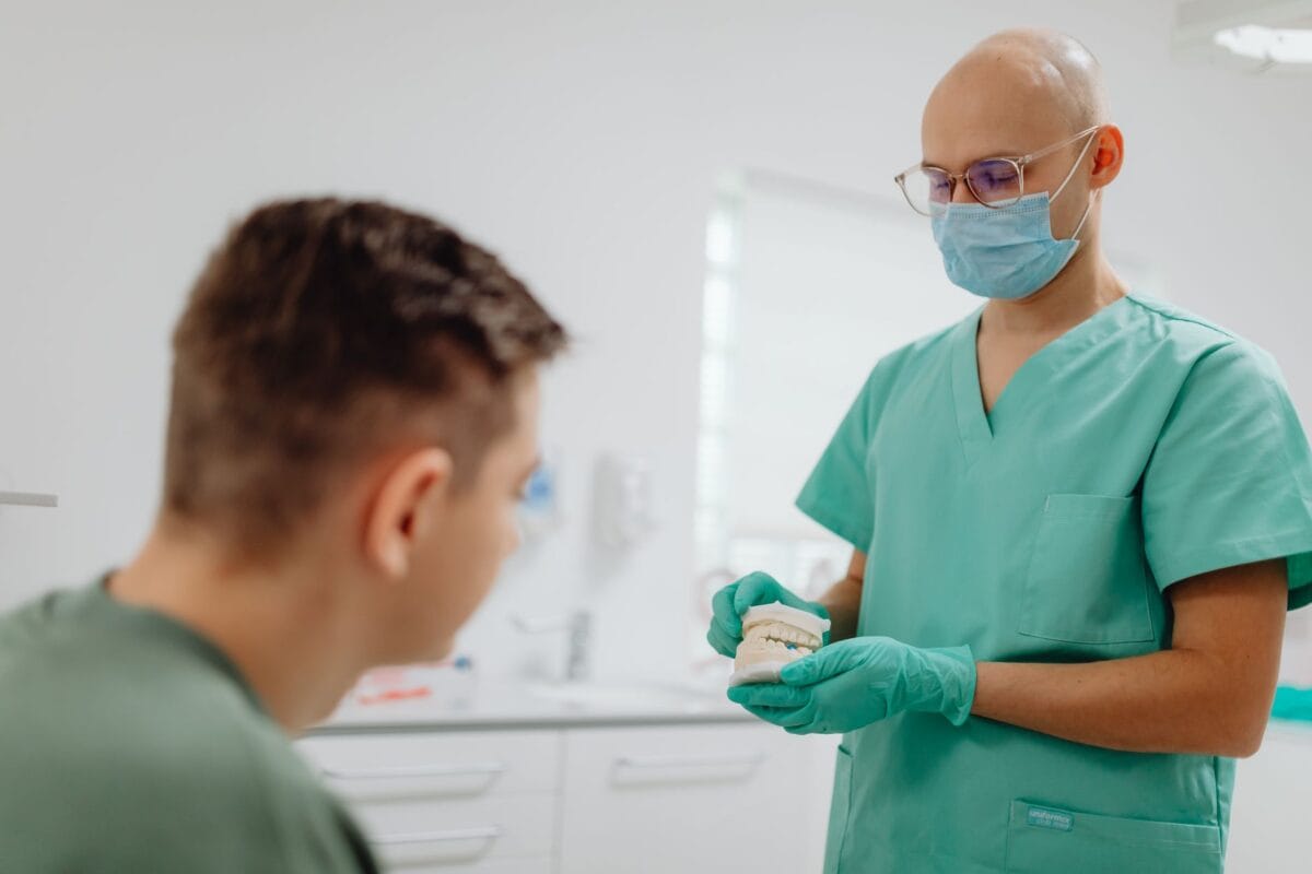 Dentist explaining dental procedure to patient - Friendly Dental of Worcester Cosmetic dentistry myths explained by dentist